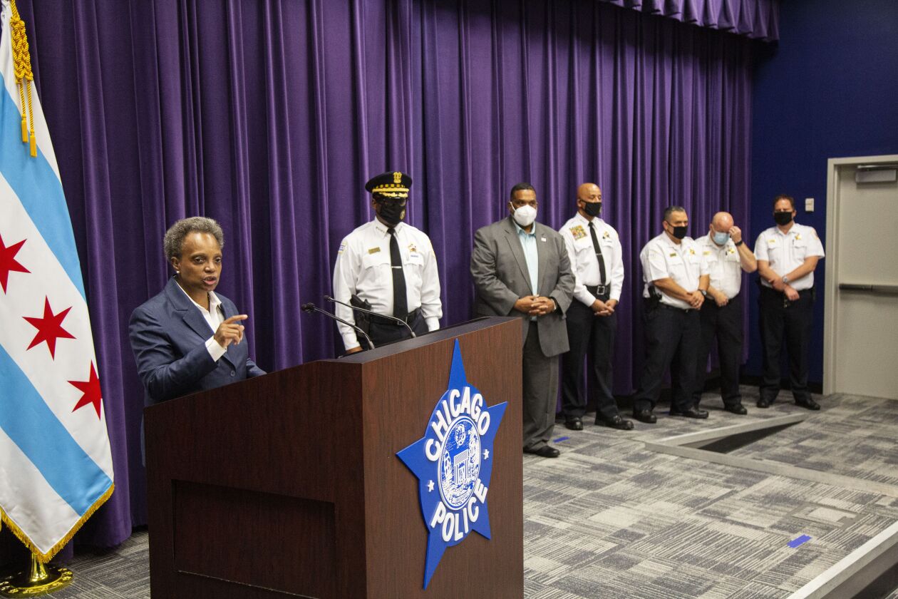 Mayor Lori Lightfoot answers questions regarding a police shootout and looting in front city officials during a news conference at the Chicago Police Headquarters at 3510 S Michigan on Monday.